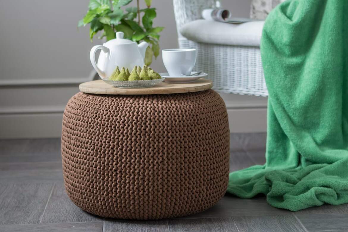Knitted pouf with tea and snacks