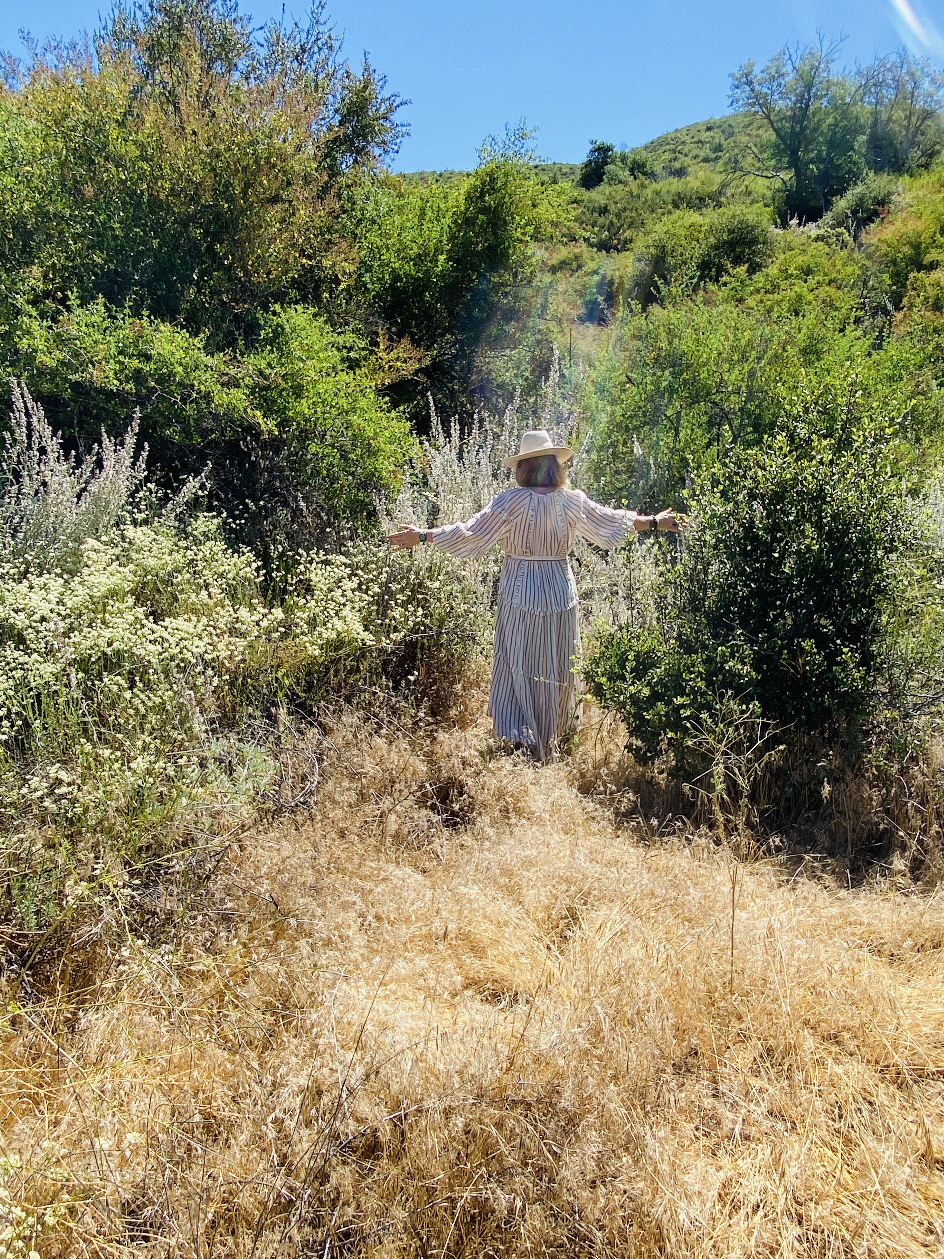 Woman standing in a field of white sage
