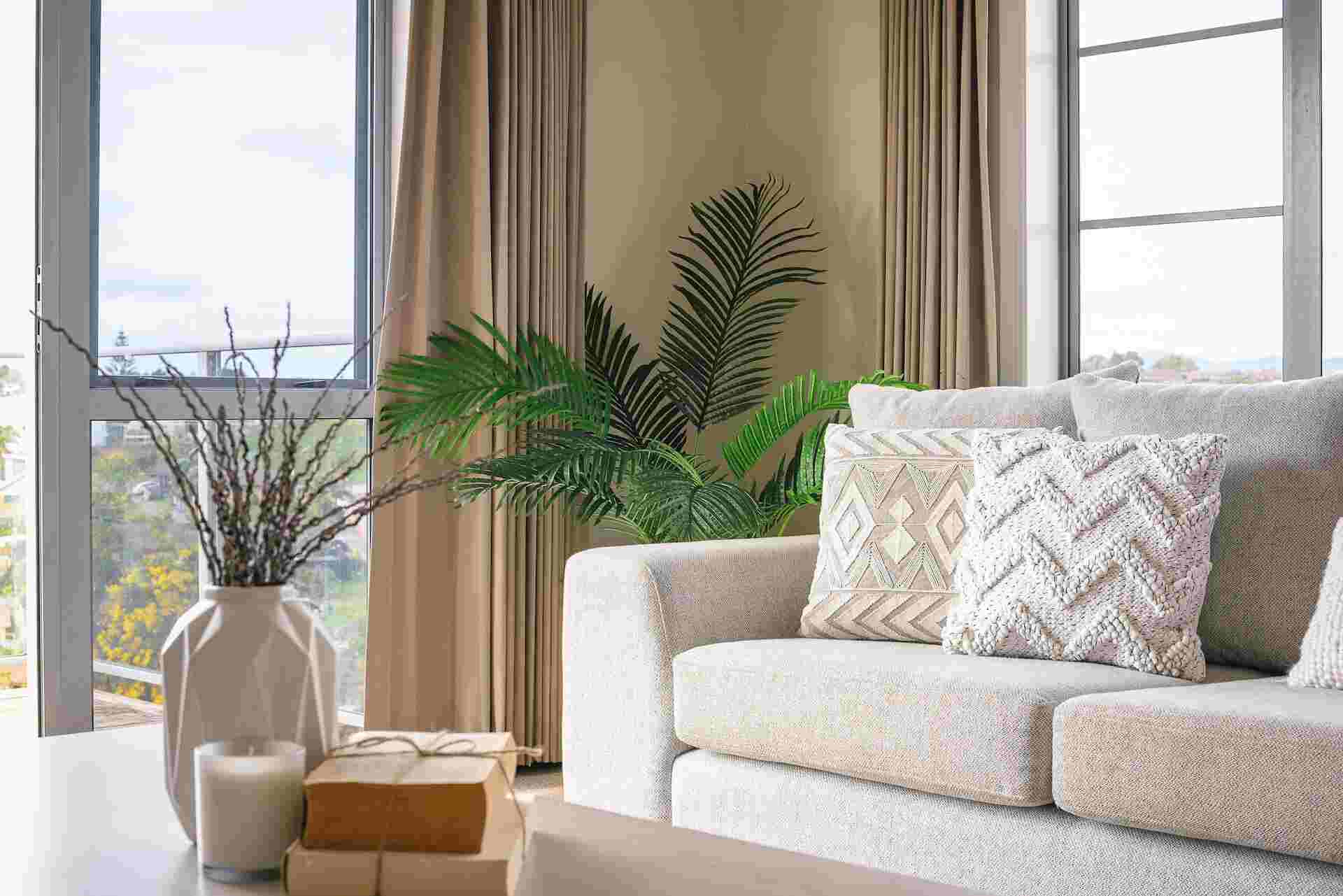 Gray white sofa with throw pillows and floral