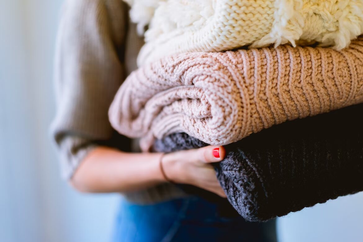 Person holding sustainable, artisan blankets